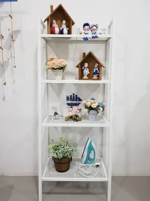a white shelf with figurines and houses and a plant at BLUE DOME (Santorini) @ Night Market, Cameron Highlands in Brinchang