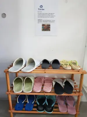 a wooden shelf with pairs of shoes on it at BLUE DOME (Santorini) @ Night Market, Cameron Highlands in Brinchang