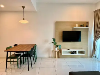 a dining room with a table and a tv at Ipoh Onsen family suite l Lost World view in Tambun