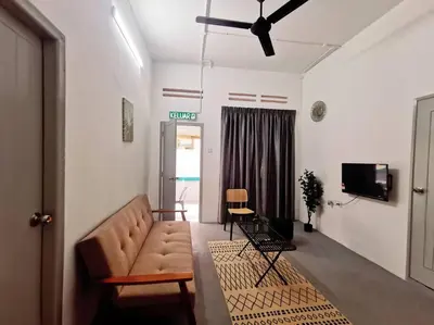 a living room with a couch and a tv at Ipoh town centre glamping home 13pax in Ipoh