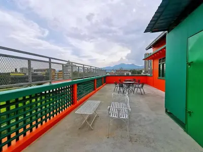 a balcony with chairs and tables on a building at ipoh town centre - nordic 7pax in Ipoh