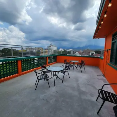 a patio with tables and chairs on a balcony at Ipoh town centre -rustic home 4pax (studio 5) in Ipoh