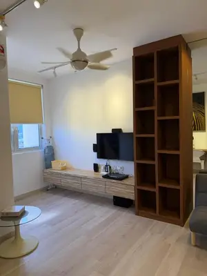 a living room with a flat screen tv and a couch at 118 Apartment Tanjung Tokong by Yen's Sojourn in George Town