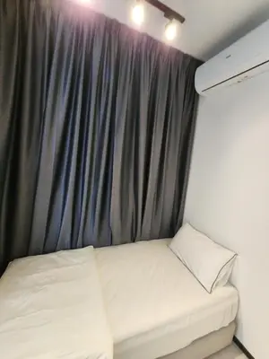 a bed in a small room with a curtain at Executive Urban Suites - George Town @ Penang in Jelutong