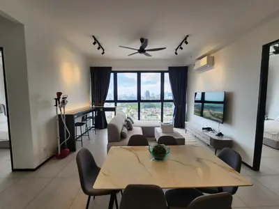 a living room with a table and a couch at Executive Urban Suites - George Town @ Penang in Jelutong
