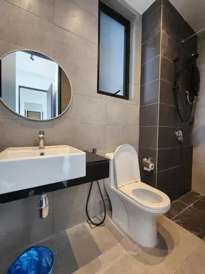 a bathroom with a sink and a toilet and a mirror at Executive Urban Suites - George Town @ Penang in Jelutong
