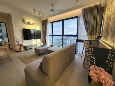a living room with a couch and a large window at Executive Urban Suites - George Town @ Penang in Jelutong