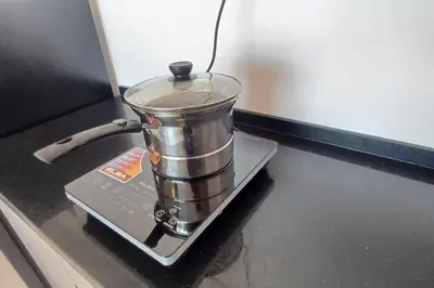 a metal bucket sitting on top of a stove at Stylish Urban Suite Penang - with infinite pool in Jelutong