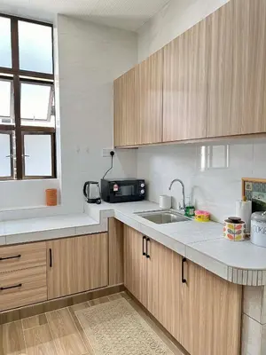 a kitchen with wooden cabinets and a sink at Pertak Malai @ Kuala Kubu Bharu in Kuala Kubu Baharu