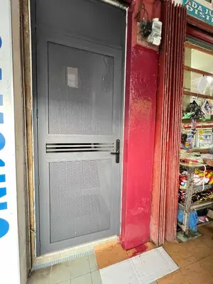 a door in a room with a red wall at Pertak Malai @ Kuala Kubu Bharu in Kuala Kubu Baharu