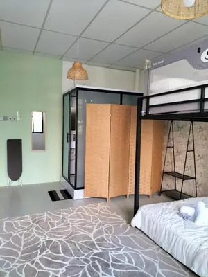 a bedroom with a bunk bed and a desk at le melur guest house in George Town