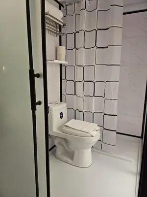 a bathroom with a white toilet in a room at le melur guest house in George Town
