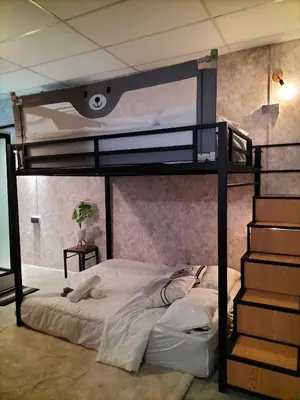 a bedroom with a bunk bed and a staircase at le melur guest house in George Town