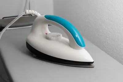 a white and blue phone sitting on a desk at Brown Mansion CoLiving in George Town