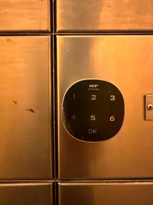 a close up of a black button on a metal cabinet at Champs Elysees Homestay by Landmark @ Kampar in Kampar