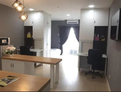 a room with a table and chairs and a bedroom at Champs Elysees Homestay by Landmark @ Kampar in Kampar