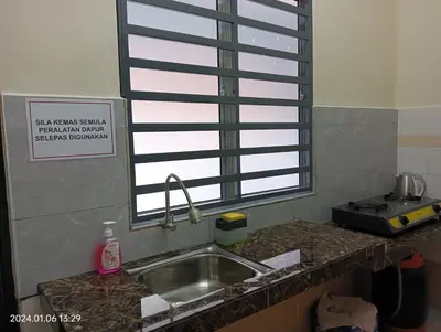 a kitchen counter with a sink and a window at Homestay Itqan Seri Iskandar in Seri Iskandar