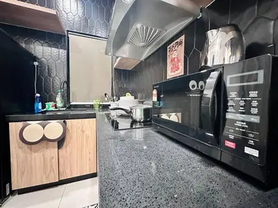 a kitchen with a stove and a microwave at (New) Fettes Villa for 20Pax @CentralPenang/Gurney in George Town