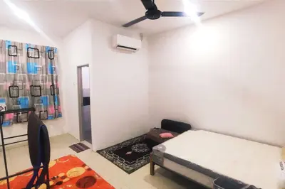 a bedroom with a bed and a ceiling fan at Alysha Homestay in Kuala Lipis