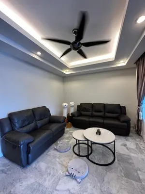 a living room with a couch and a ceiling fan at Claire Home Stay in Ipoh