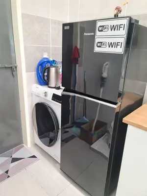a washer and dryer in a kitchen at One Sweet Homestay Kulim Hi-Tech utk Msliim shj in Kulim