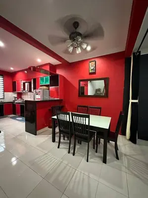 a dining room with red walls and a table and chairs at Pa&Ma HomeStay Kulim 4R3B fully aircond in Kulim