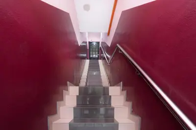 a stairway with red walls and a red stair case at OYO 89960 Manjung Inn Hotel in Seri Manjung