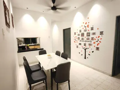 a dining room with a white table and chairs at TL LEGEND HOMESTAY Ipoh garden east in Ipoh