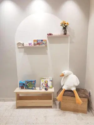 a stuffed duck sitting on a bed in a room at TL LEGEND HOMESTAY Ipoh garden east in Ipoh