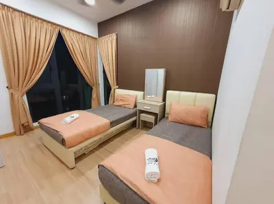 a hotel room with two beds and a television at UN1 28 Jazz Massage Chair 5 min GMC Gurney \u5957\u623f in Tanjong Tokong