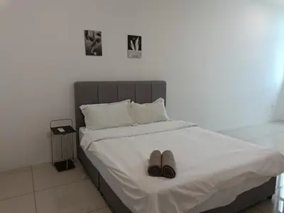 a bed with two pairs of shoes sitting on it at Cozy 4 bedrooms House by Mr Homestay, 3 mins to Kulim Landmark Centre in Kulim