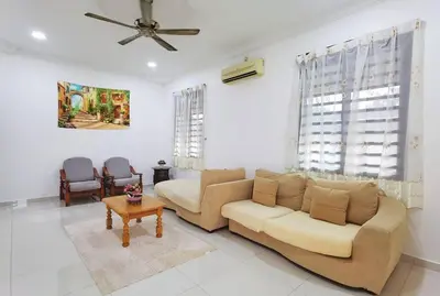 a living room with a couch and a table at Ipoh stadium-18 pax (mahjong/5min to town) pets friendly in Ipoh