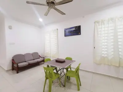 a living room with a table and chairs and a couch at Ipoh stadium-18 pax (mahjong/5min to town) pets friendly in Ipoh