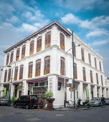 a white building with many windows on a street at Ren I Tang Heritage Inn in George Town