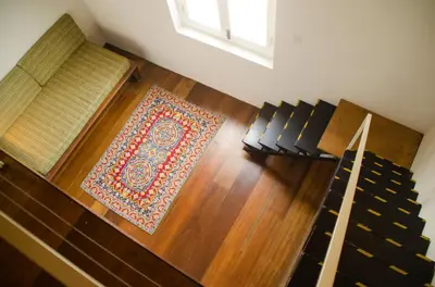 an overhead view of a living room with a rug and stairs at Ren I Tang Heritage Inn in George Town