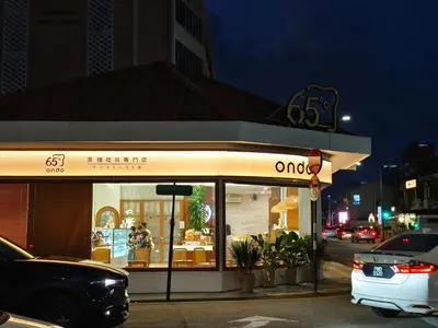 a store front of a store with a car parked outside at ZOOM HOTEL in George Town