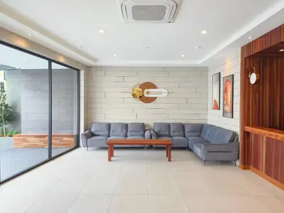 a living room with a couch and a table at ZOOM HOTEL in George Town