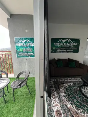 a living room with a couch and a table and chairs at CRYSTAL D CAMERON HOMESTAY in Cameron Highlands