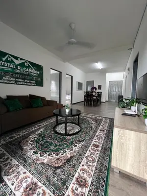 a living room with a couch and a table on a rug at CRYSTAL D CAMERON HOMESTAY in Cameron Highlands