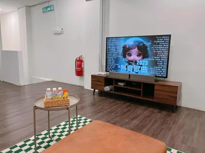 a living room with a flat screen tv and a table at Penang Heritage Home in George Town