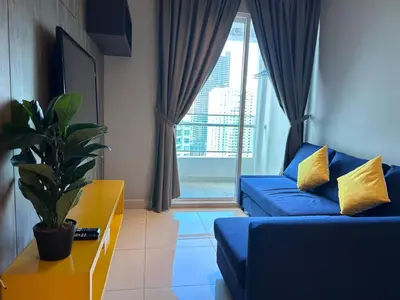 a living room with a blue couch and a window at Seaview Mansion One 2R2B George Town Gleneagles Gurney Komtar by Cozy Cottage Haven in George Town