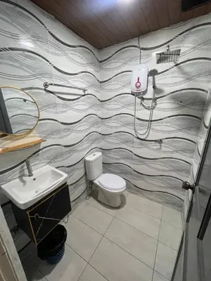 a bathroom with a toilet and a sink at Nahdhoh Hotel in Kubang Semang