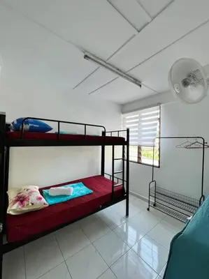 a bedroom with two bunk beds in a room at Sarah homestay Muslim Permatang Pauh in Permatang Pauh