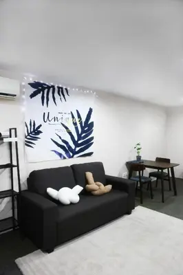 a living room with a black couch with two ducks on it at Private GameRoom and Cinema at The CEO Penang in Bayan Lepas