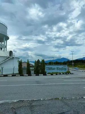 a building with a sign on the side of a road at Rana Homestay Ipoh Perak in Tanjung Rambutan
