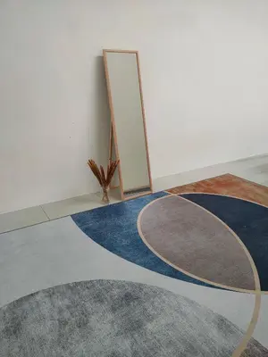 a rug on the floor in a room with a mirror at Rana Homestay Ipoh Perak in Tanjung Rambutan