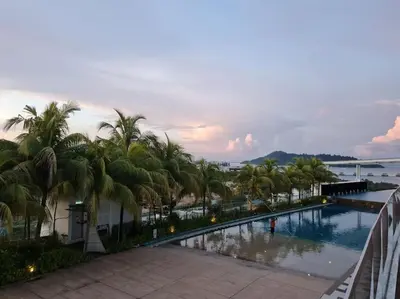 a view of a swimming pool with palm trees at Southbay Seaview Condo A11 #Queensbay #SPICE in Bayan Lepas