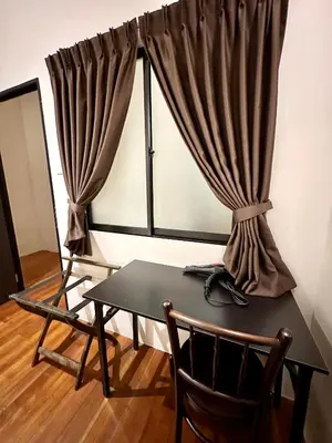a table and chairs in a room with a window at Madras Inn 58-1 in George Town