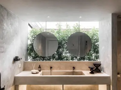 a bathroom with a large sink and two mirrors at Heritage Boutique Home in George Town