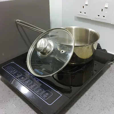 a pot sitting on top of a stove at Veneto Penang homestay 3BR with infinity pool in Jelutong